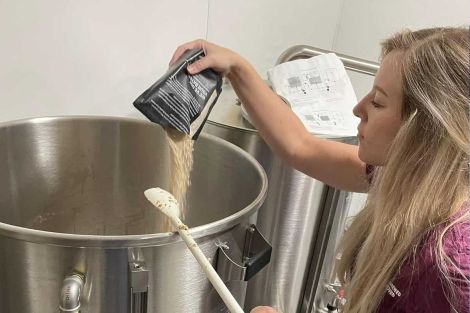 Rebekah adds hops to a batch