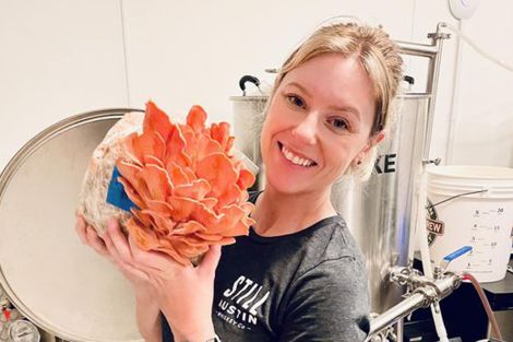 Rebekah showing off her Pink Oyster Mushrooms